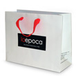 Hi gloss laminated paper shopping bags printed with 2 colors with grosgrain ribbon handles and printed bottom board.